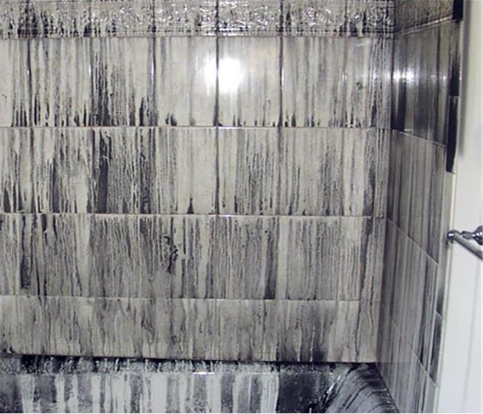 soot covering the walls of a fire damaged bathroom