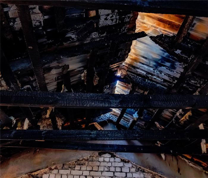 a fire damaged ceiling that is burnt and almost broken